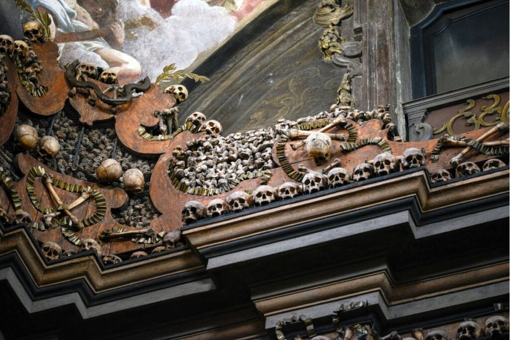 The church draws in visitors due to its walls covered in skulls and bones.
