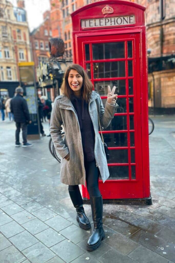 At one of the iconic phone booths in London this past winter.