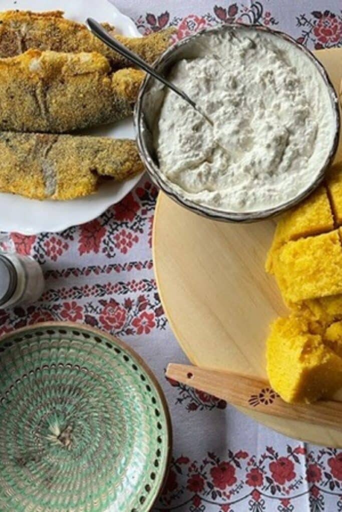 Pastravi is a fried fish with cornbread and sour cream - a traditional food in Romania.